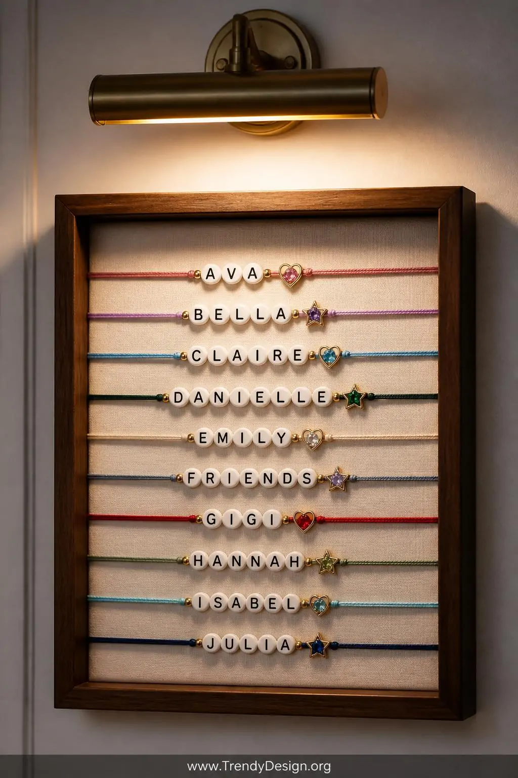 Closeup shot of a small shadow box wall accent displaying personalized initial friendship bracelets with alphabet beads and t