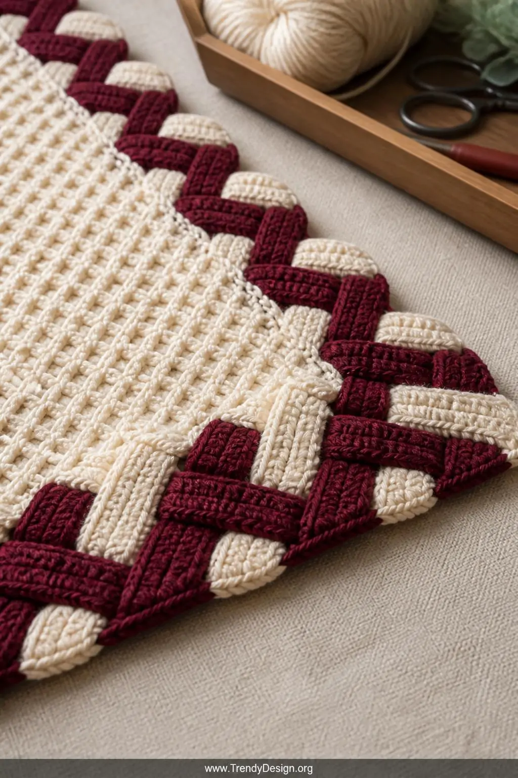 A close-up photorealistic shot of a finished C2C blanket edge blocked flat on a natural linen surface in a bright craft studi