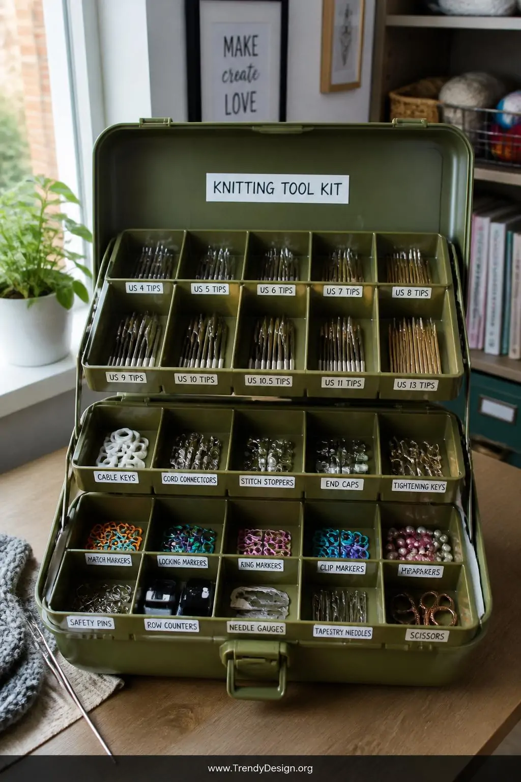 A wide-shot photorealistic image of a well-organized craft table corner where a large olive green fishing tackle box sits ope
