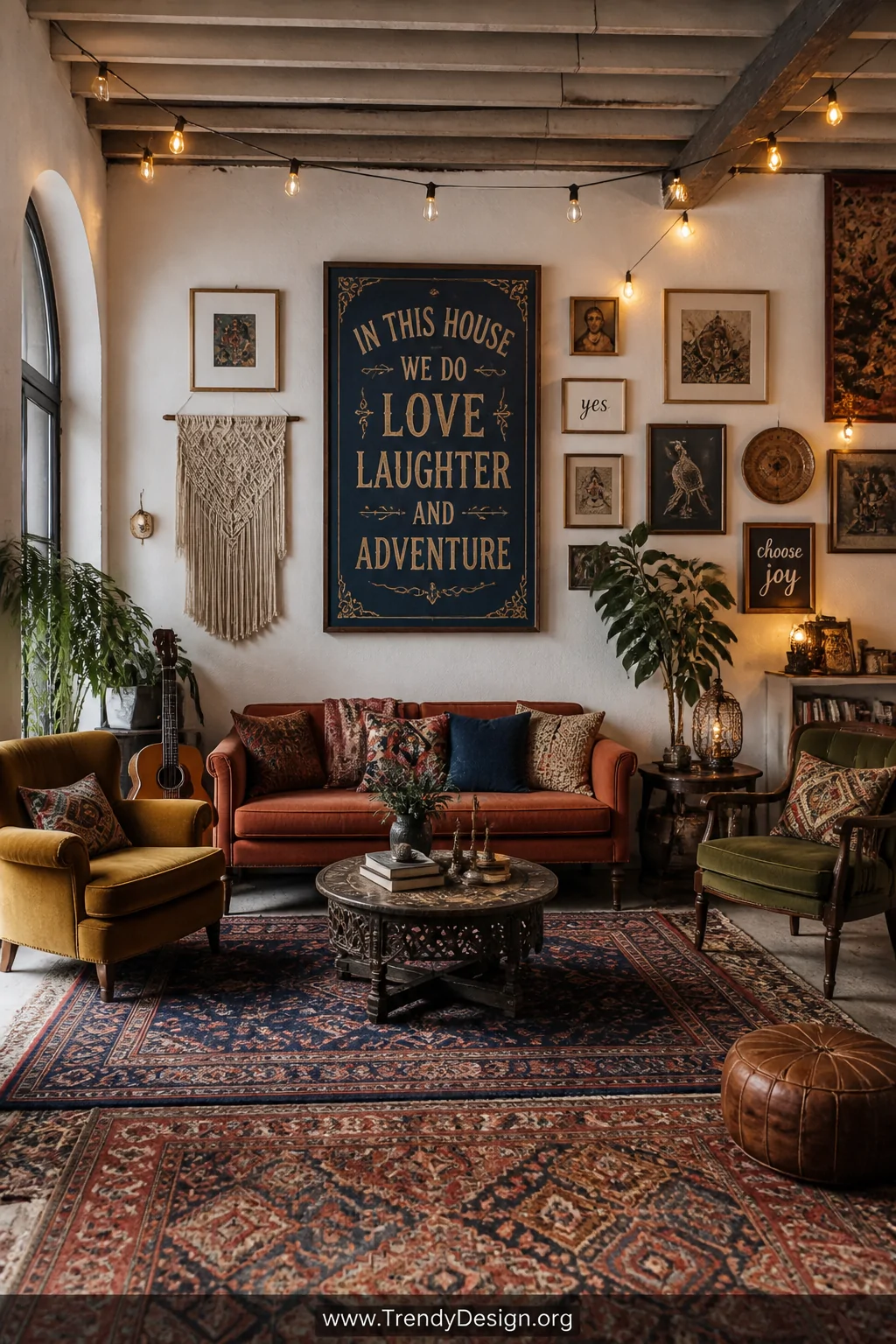 Wide shot of an eclectic bohemian living room featuring a gallery wall centerpiece with a large custom hand-painted sign in d