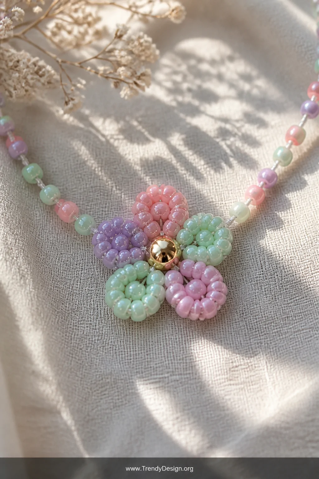 A detailed close-up shot of a floral medallion pony bead necklace centerpiece resting on a textured linen cloth, featuring so