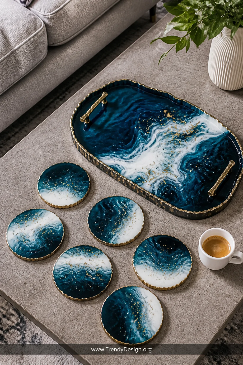 A medium overhead shot of a styled coffee table displaying a set of six resin coasters with swirling ocean wave patterns in d