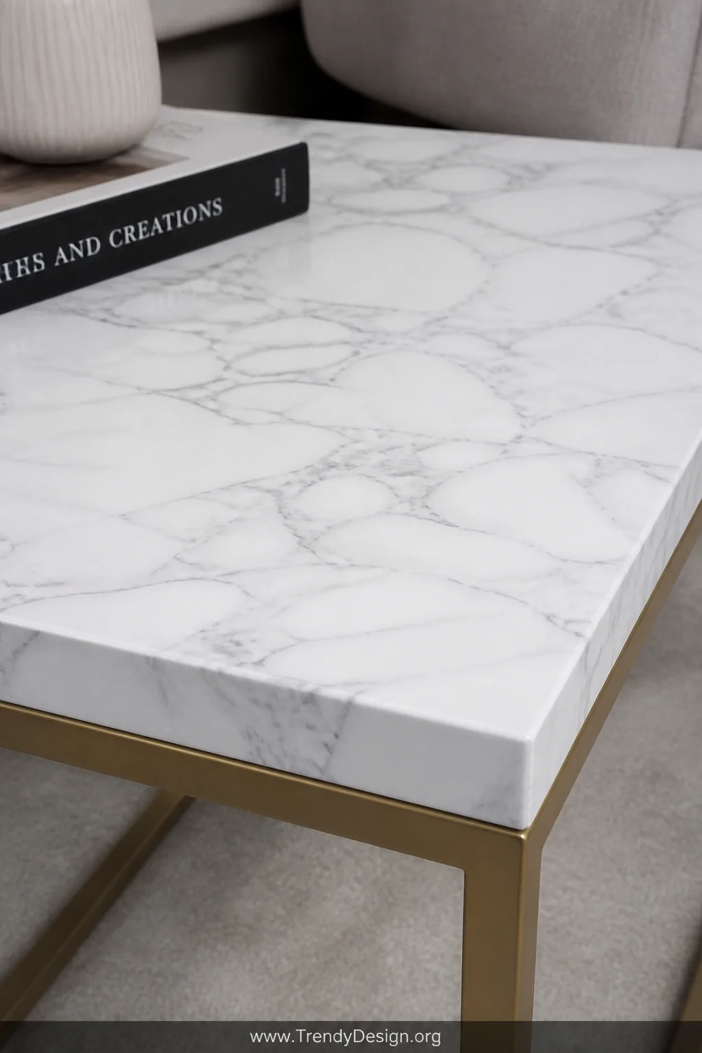 A close-up detail shot of a side table surface freshly covered in white Carrara marble peel-and-stick contact paper with cris