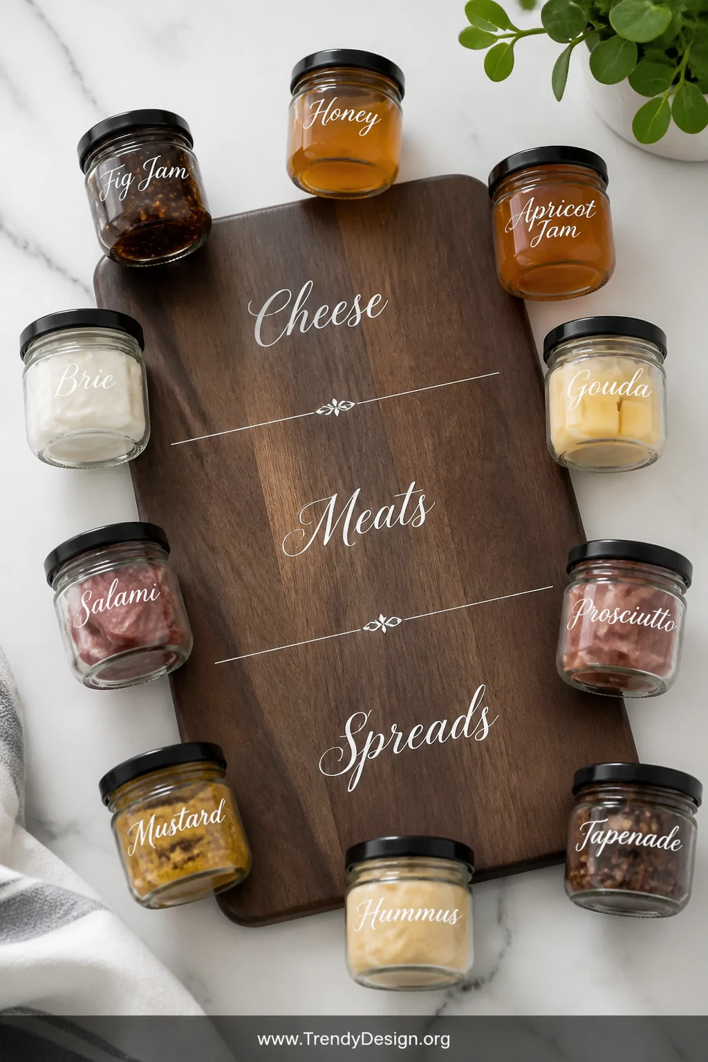 A close-up overhead flat-lay shot of a dark walnut serving board with elegant white vinyl labels reading 