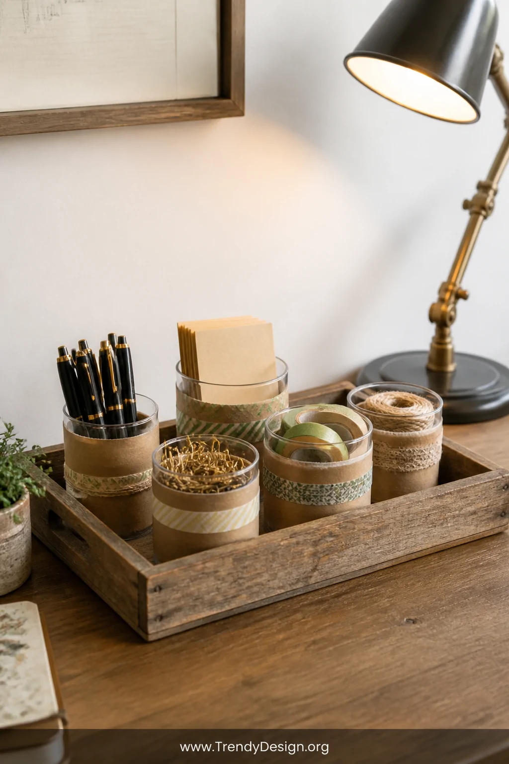 A medium shot of a tidy wooden desk surface featuring a shallow reclaimed wood tray filled with small plastic containers wrap
