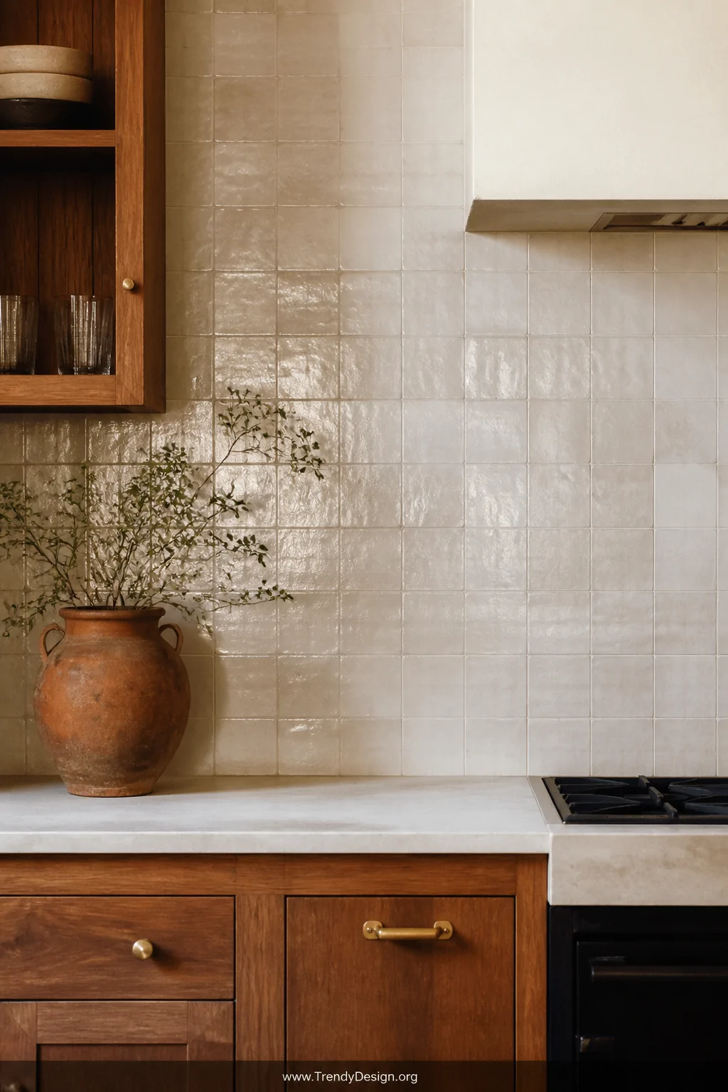 Medium shot of a kitchen backsplash covered in handmade zellige tiles in creamy white with subtle color variation and ripplin