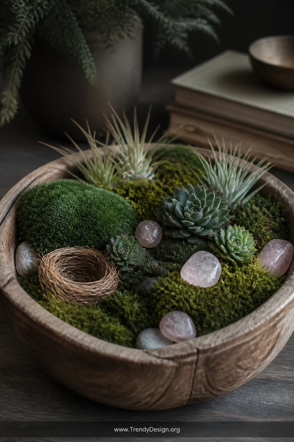 A close-up detail shot of a rustic wooden dough bowl lined with velvety preserved sheet moss in deep emerald and olive tones,