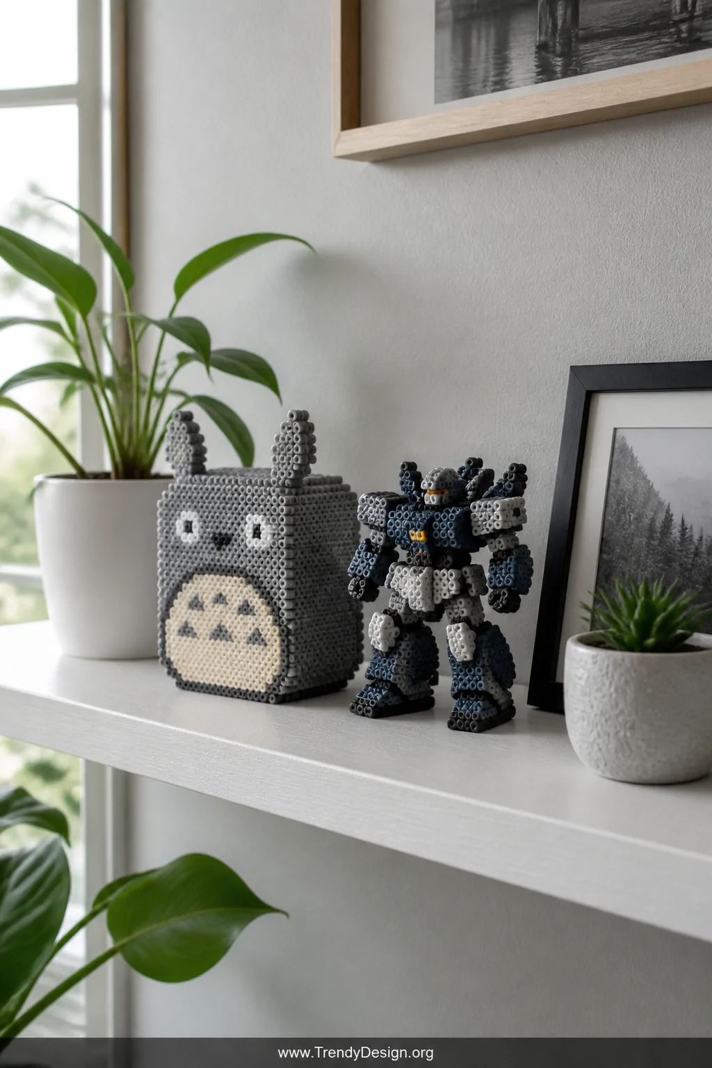 Wide shot of a styled floating shelf display featuring several completed 3D Perler bead figures   a cube Totoro in gray and w
