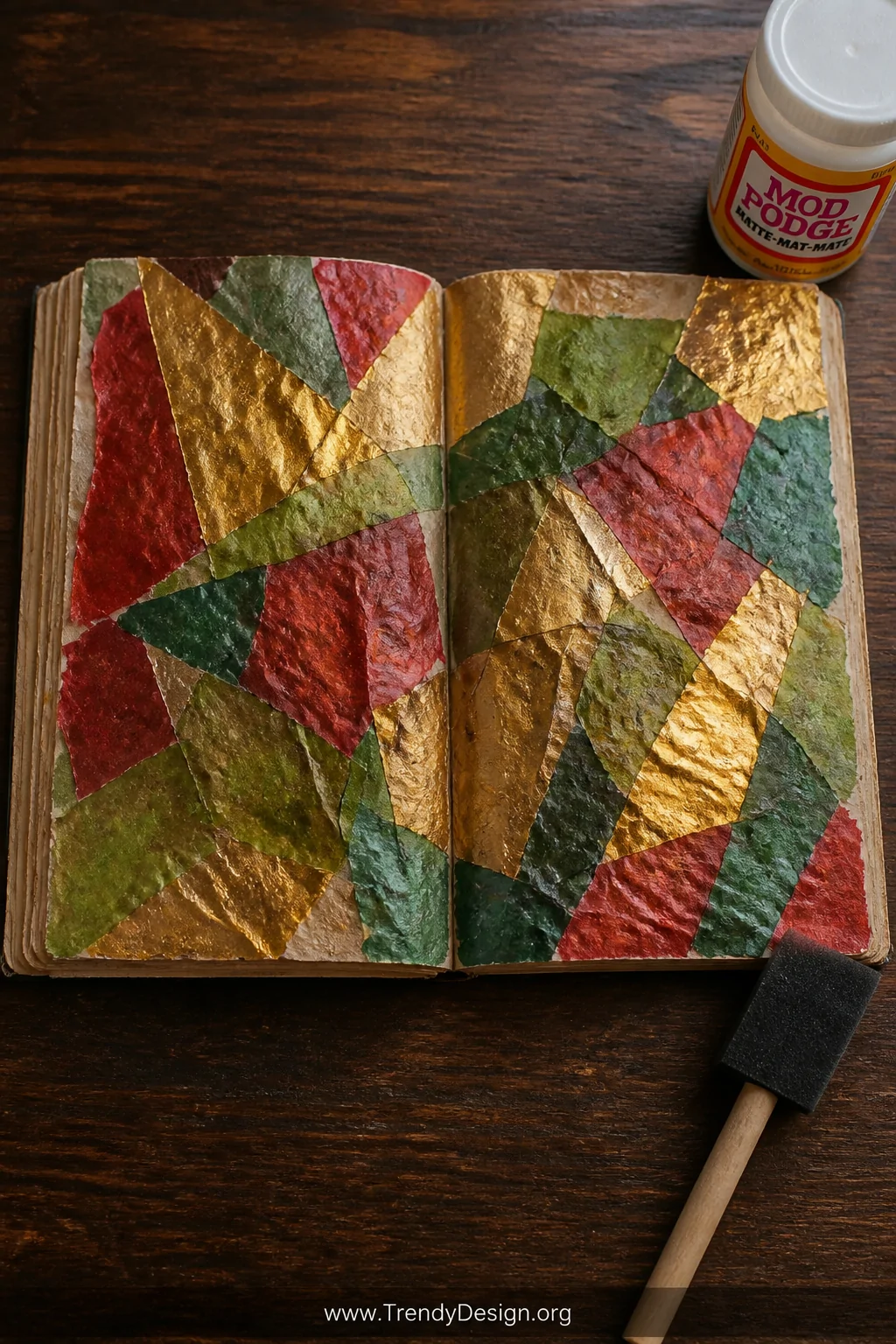 Medium overhead flatlay shot of an open junk journal spread on a dark oak desk, showing translucent red, green, and gold tiss