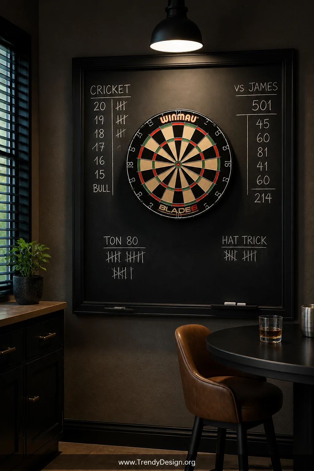 A medium shot of a game room corner with a large matte black-framed chalkboard panel at least four feet square mounted behind