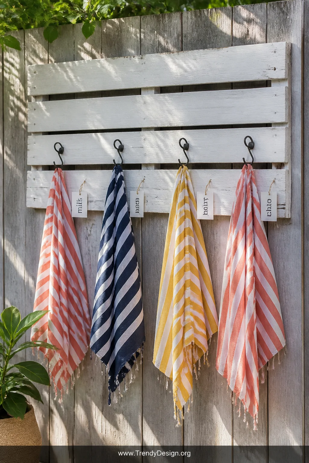 A medium shot of a weathered wooden pallet mounted on a sun-bleached timber fence, sanded smooth and painted in soft white ex