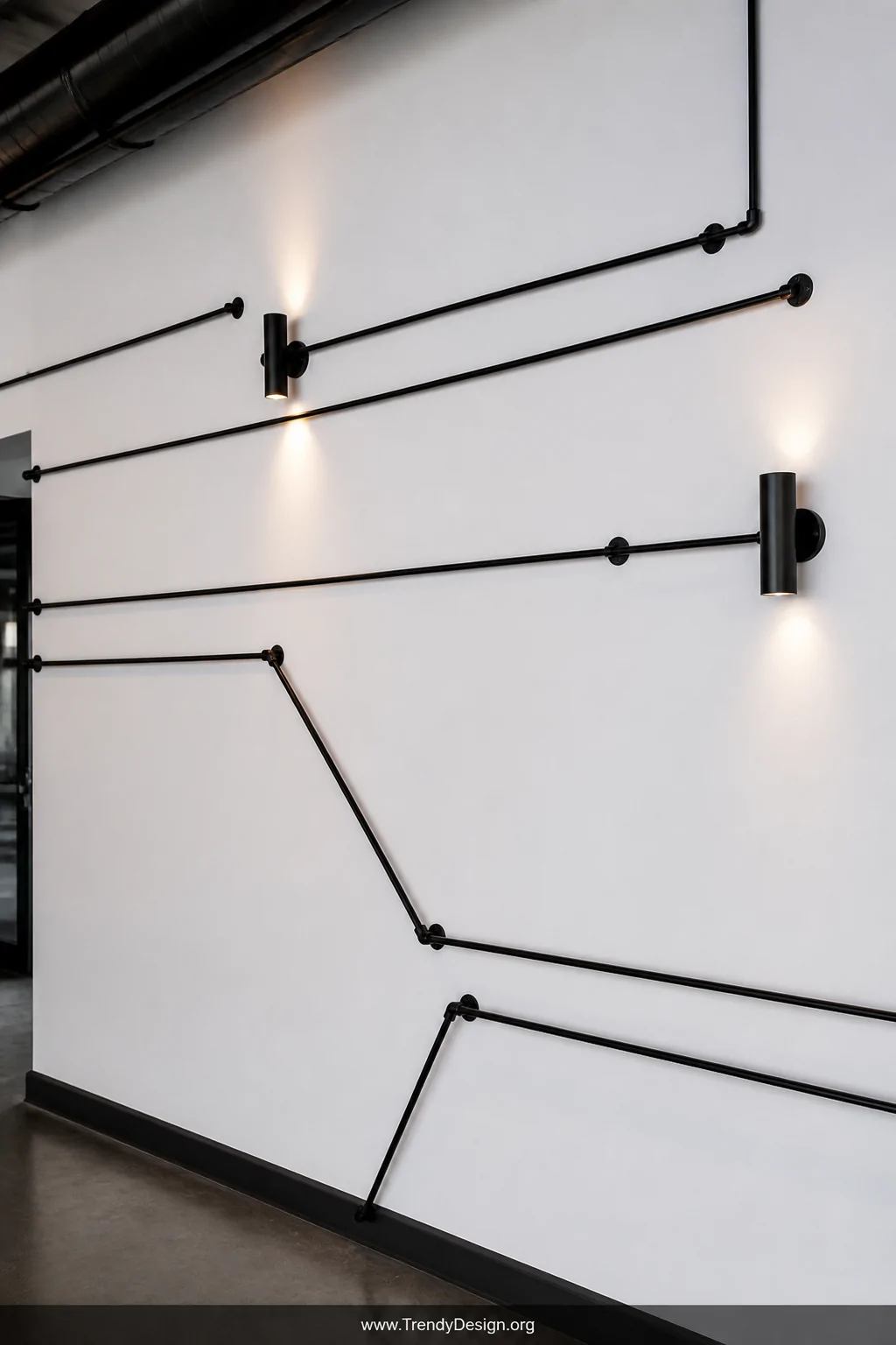 Medium shot of a stark white wall in a modern interior where black metal conduit is routed in clean, deliberate horizontal an