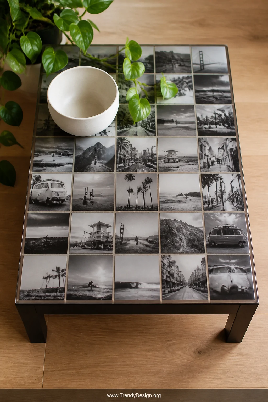 A medium overhead shot of a coffee table with a polished black and white photo collage decoupage surface, consistent square p
