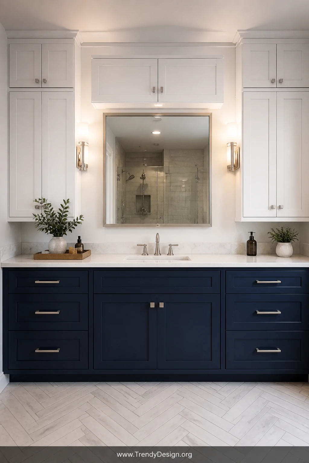 Wide shot of a stylish bathroom vanity featuring crisp white upper cabinets paired with deep moody navy lower cabinets, razor