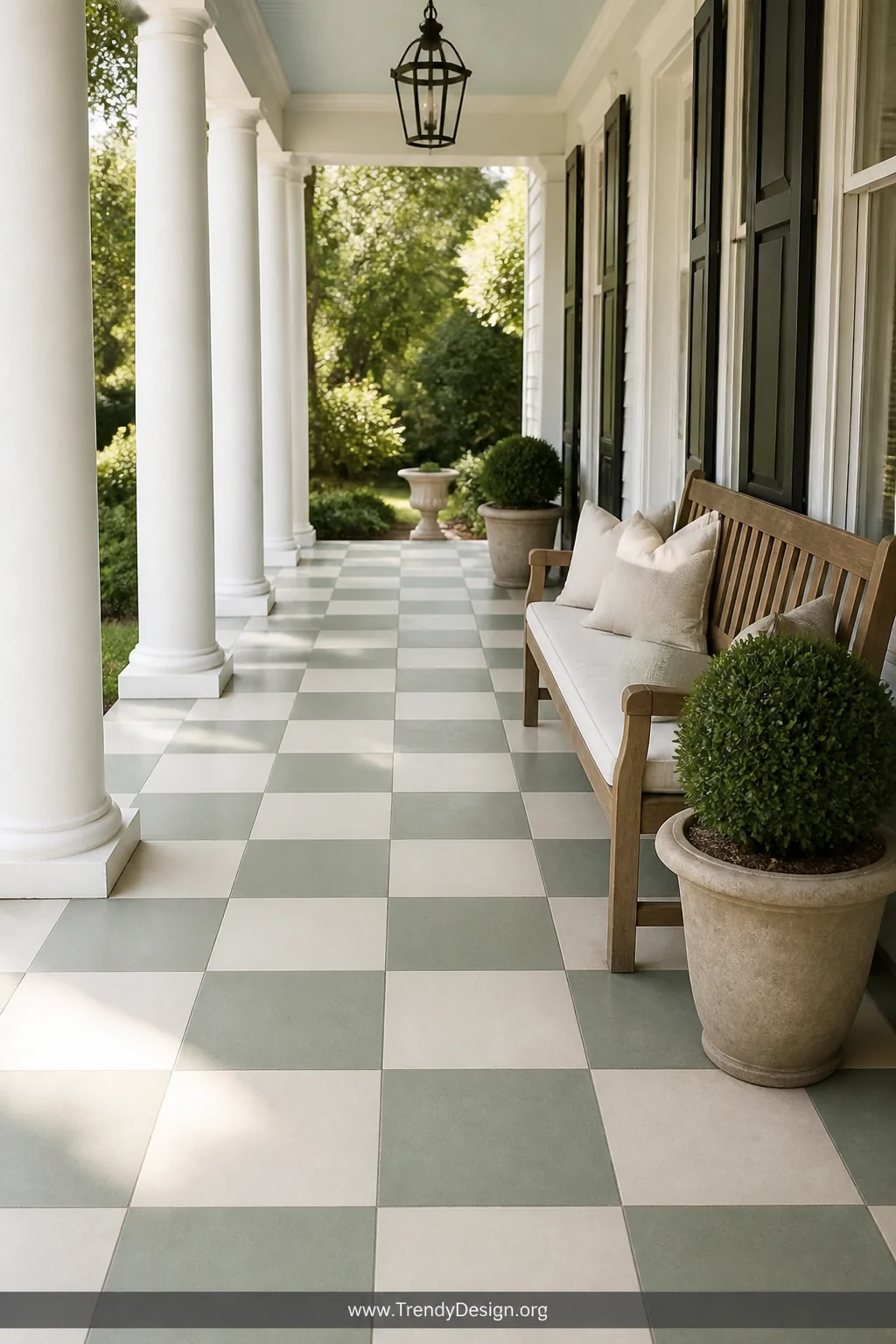 Wide shot of a classic checkerboard concrete porch floor in sage green and cream 16-inch squares, perfectly measured and seal