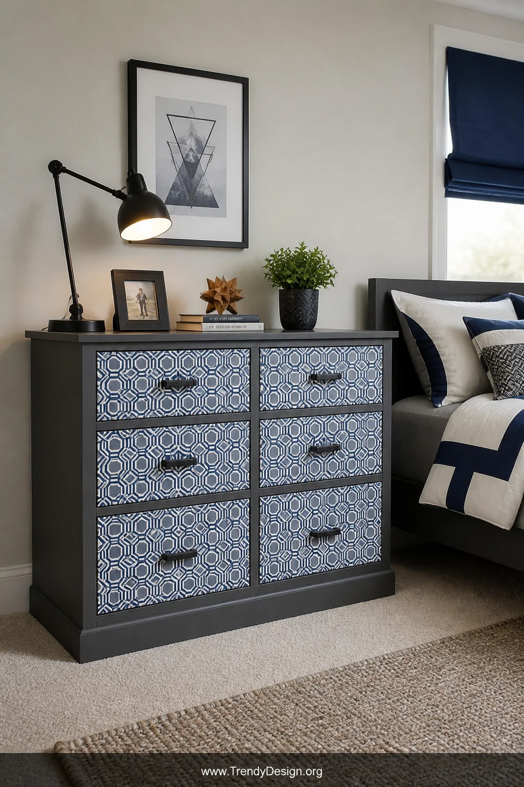 A wide room shot of a boy's dresser with each drawer front covered in scale-appropriate geometric peel-and-stick wallpaper in