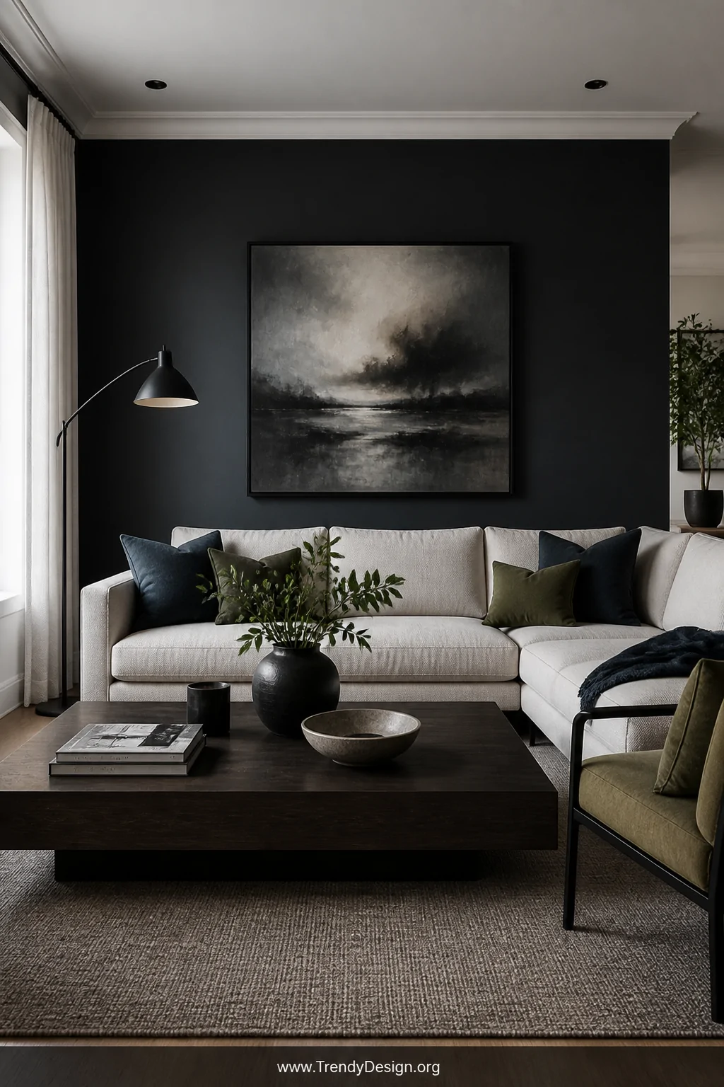 Wide shot of a living room with an off-white couch set against a deep charcoal accent wall, styled with contrast throw pillow