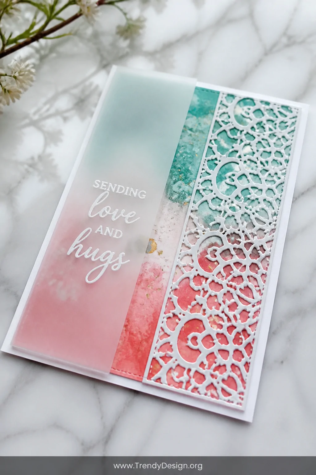 A close-up detail shot of a slimline greeting card lying flat on a white marble surface, showcasing three distinct layered pa