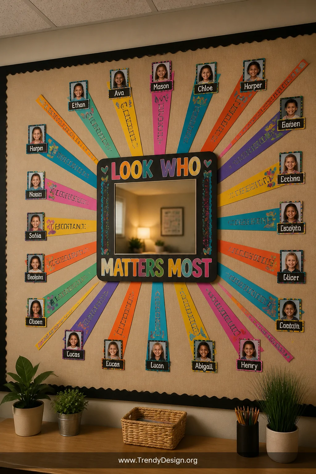 A medium shot of a classroom or office break room bulletin board centered around a square mirror tile framed with bold, multi