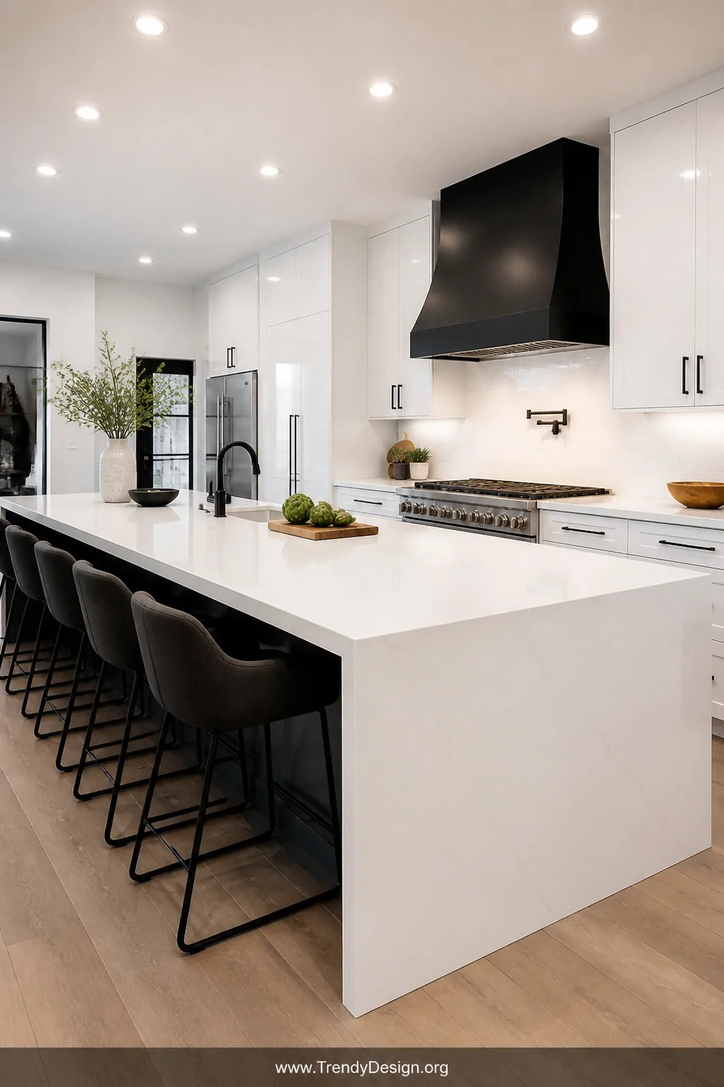 A wide shot of a sleek modern kitchen featuring an expansive countertop of large-format white porcelain tiles in a 12x24 layo
