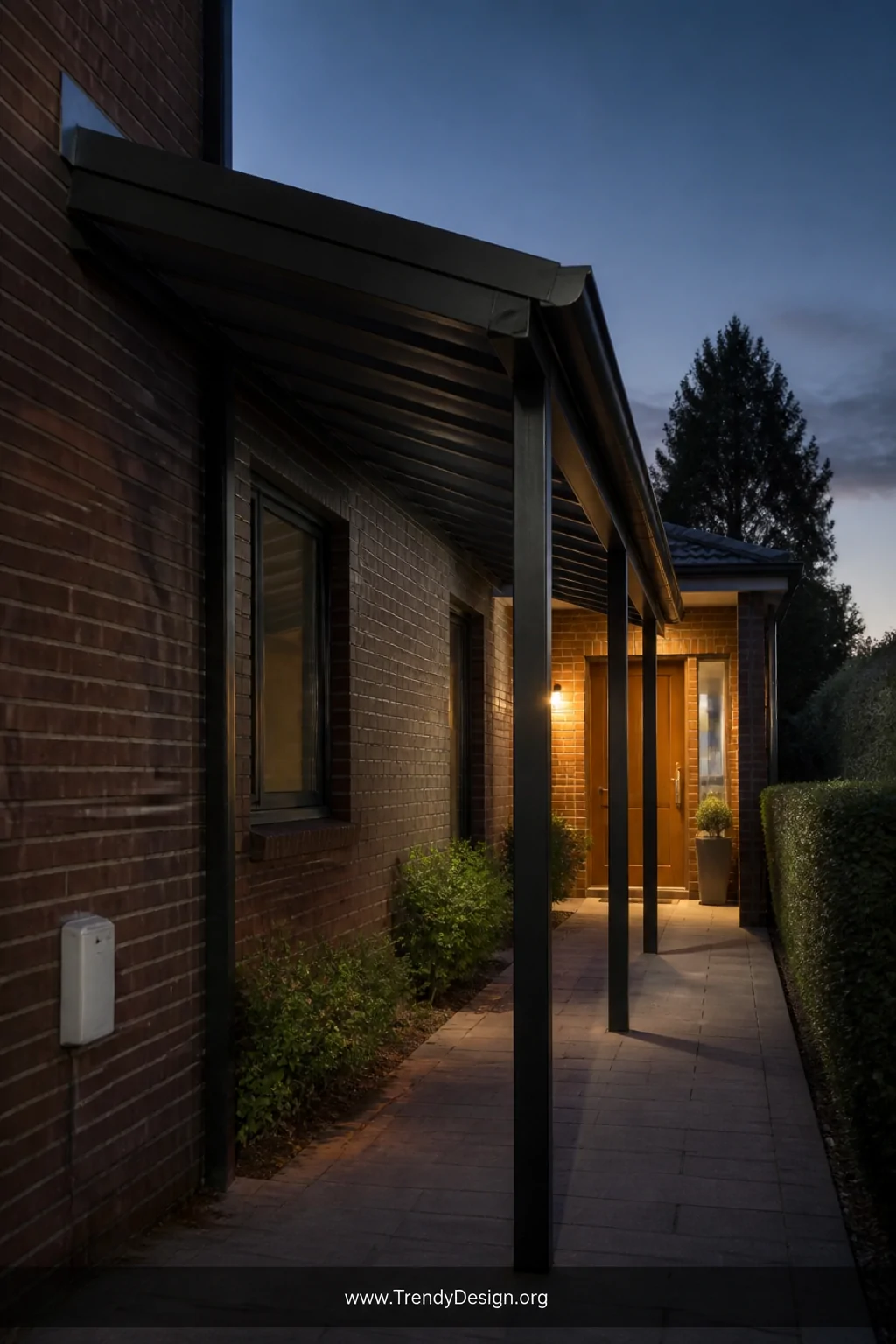 A medium exterior shot of an attached lean-to canopy kit running along a home's brick exterior wall, with matching roof-tone 