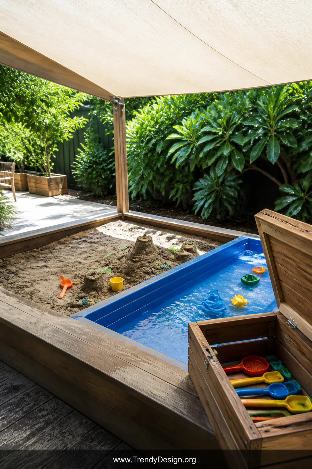 Medium photorealistic shot of a backyard sensory play zone featuring a deep rectangular sand table paired with a blue water t