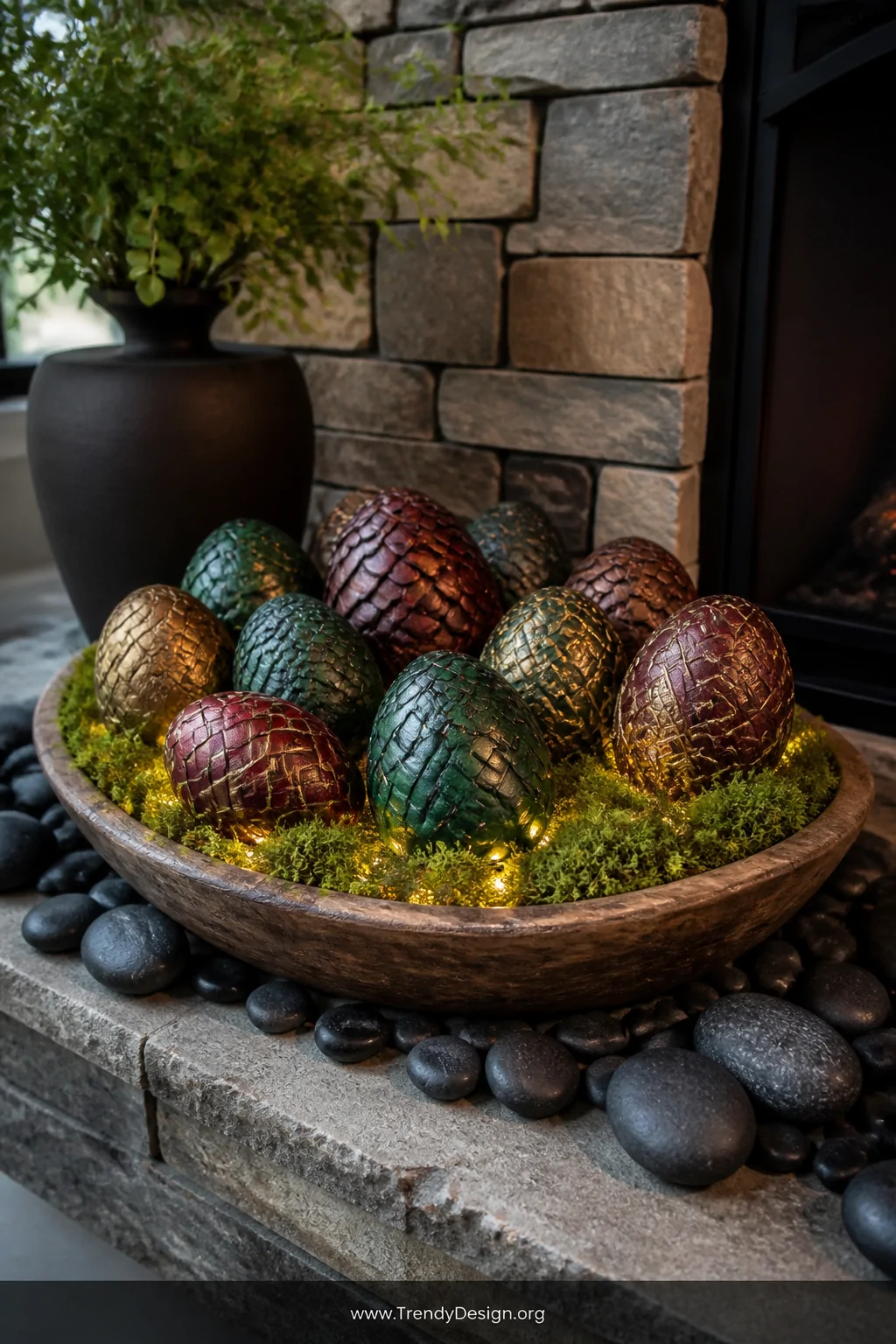 A wide styled shot of a shallow wooden bowl lined with lush green moss holding a cluster of smooth oval river rocks painted a