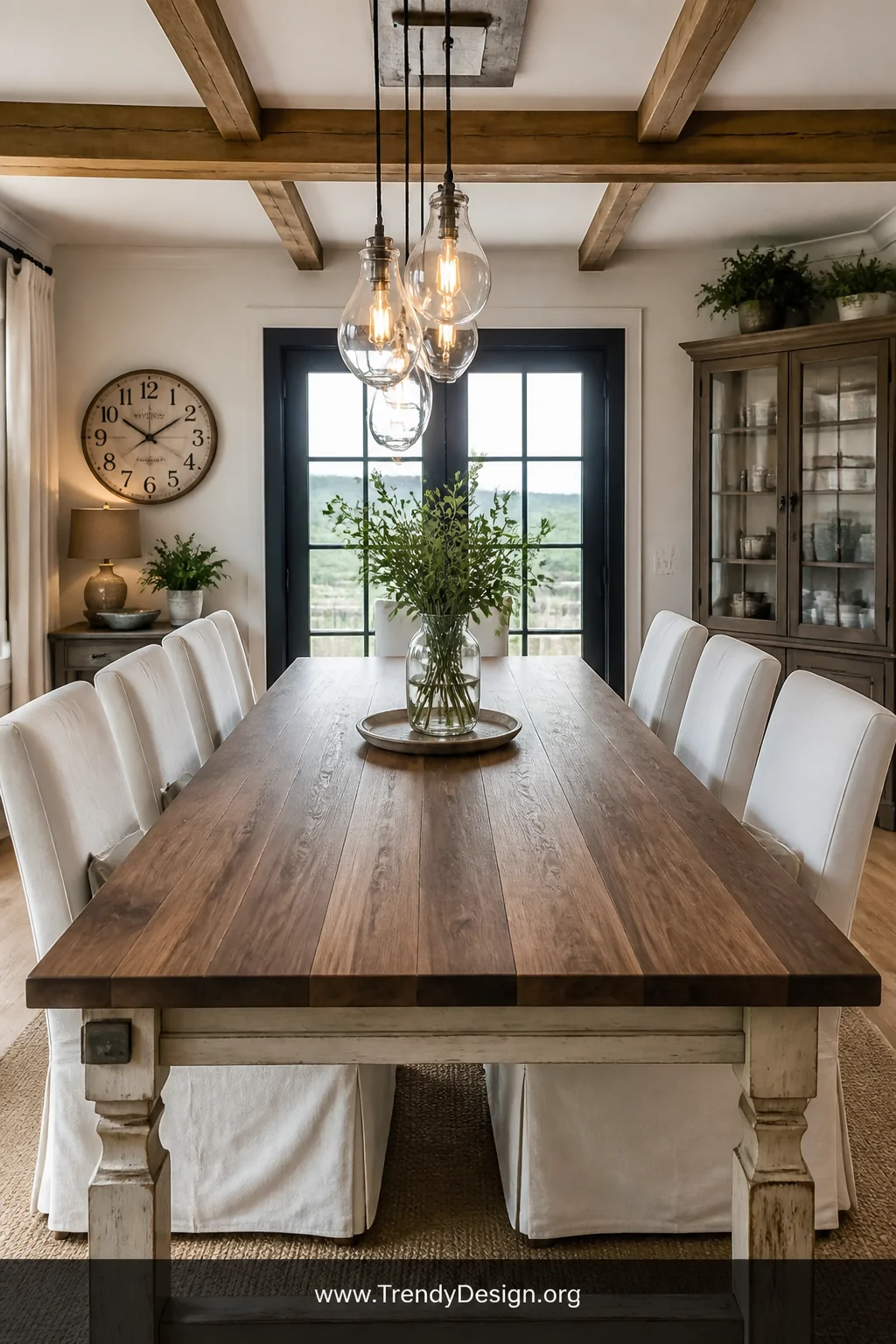 A wide interior shot of a farmhouse dining room featuring a rustic table with a freshly laid walnut butcher block top, lightl