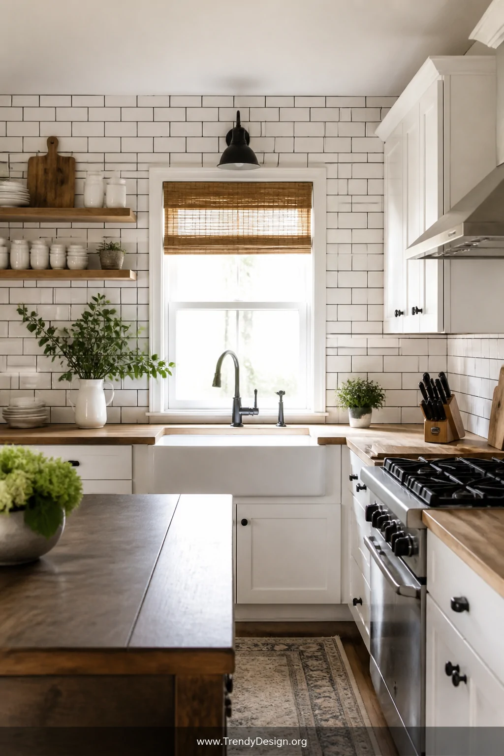 Wide shot of a bright, modern-farmhouse kitchen featuring white beveled subway tile backsplash with bold dark charcoal grout 