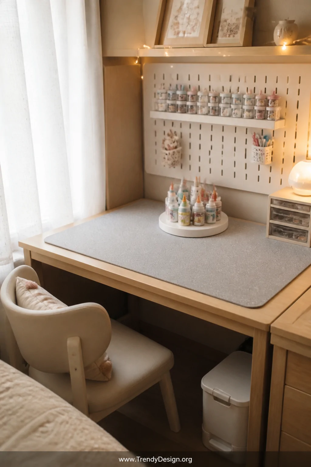Medium wide shot of a compact kids' desk in a cozy bedroom corner, surface protected by a large speckled gray silicone mat, a