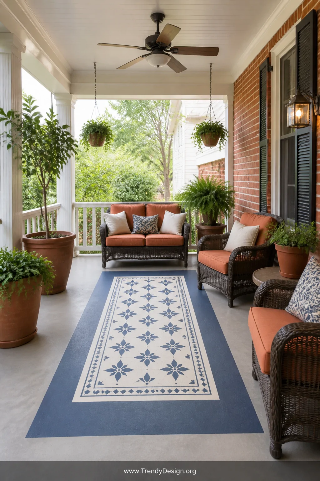 Wide shot of a covered porch featuring a painted rug design centered on the concrete floor   a rectangular bordered pattern i