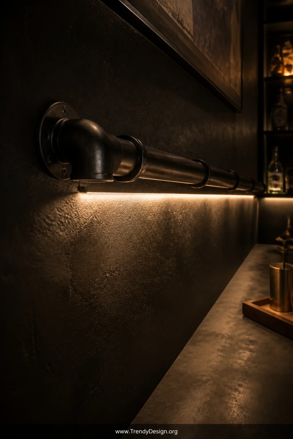 Atmospheric close-up shot of black metal conduit mounted along a dark wall in a home bar or entertainment room, with warm whi