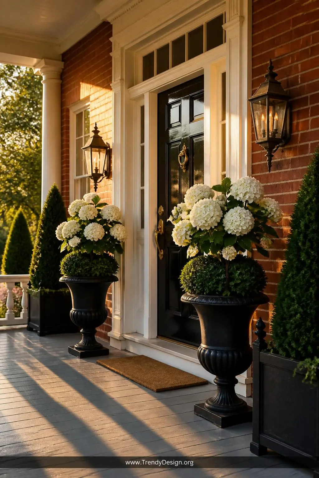 Wide photorealistic shot of a stately colonial front porch entrance at golden hour, featuring two oversized cast iron urns sy