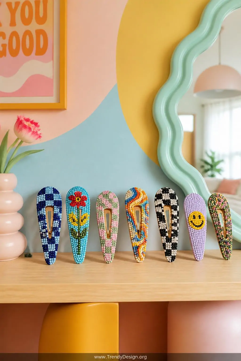 Set of colorful seed bead snap clips arranged in a fanned display on a pale wooden shelf against a pastel painted wall, bright playful nursery-style room with retro accents, bold contrasting bead patterns visible, medium shot.