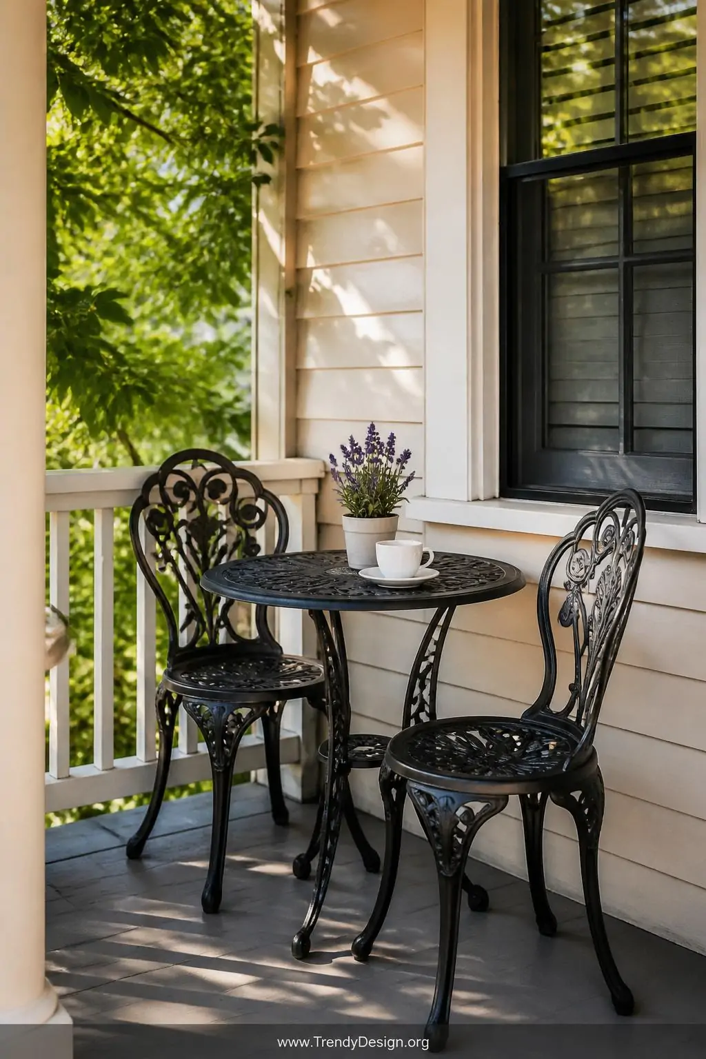 Medium shot, photorealistic interior design photography: A classic cast iron bistro table and two matching chairs in matte bl