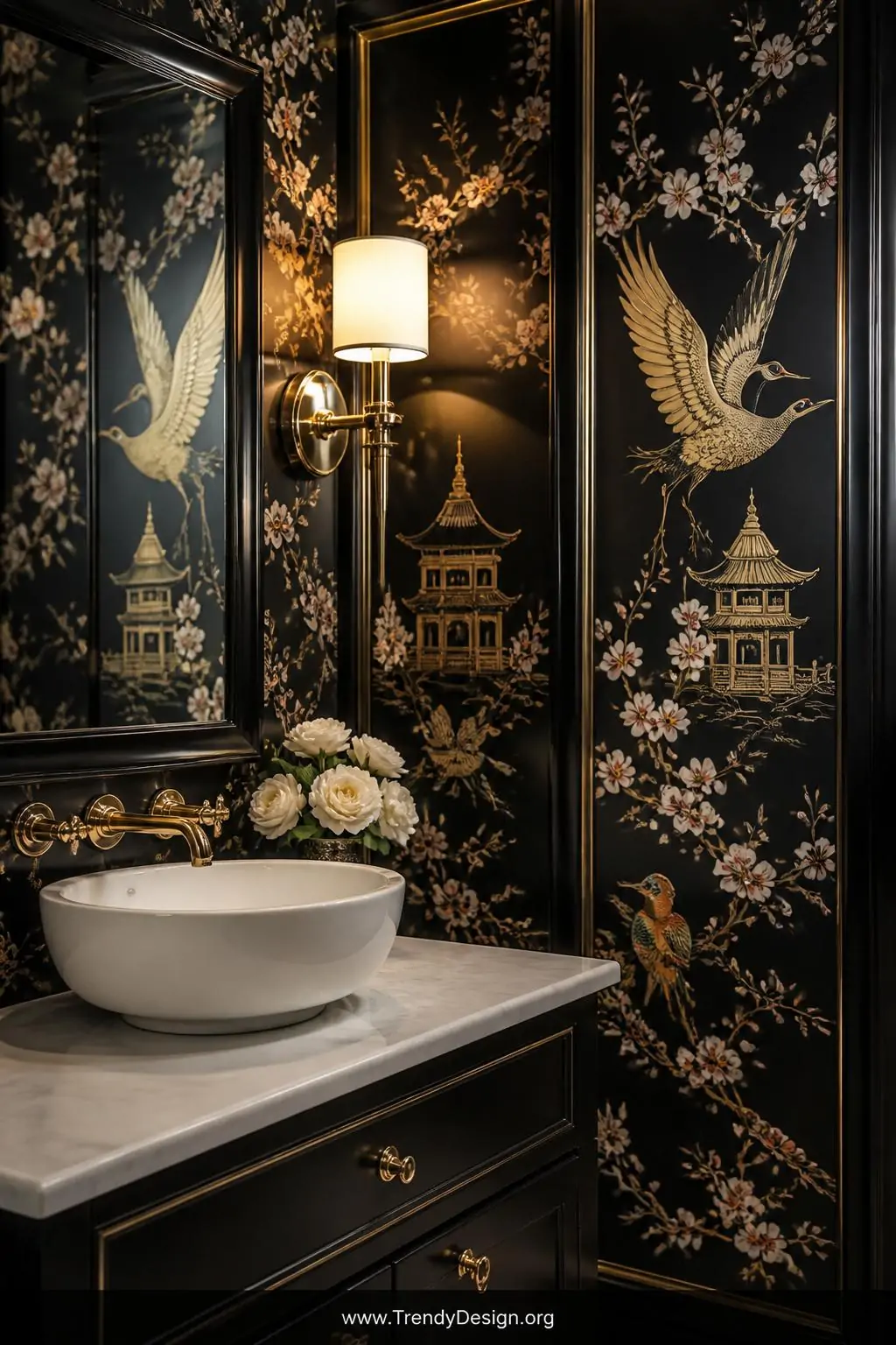 Chinoiserie wallpaper panels featuring golden cranes, cherry blossom branches, and pagodas on a dramatic black background wrapping an intimate powder room, a polished brass wall sconce illuminating jewel-toned bird details beside a white vessel sink, medium shot capturing the opulent hand-painted artistry, photorealistic.