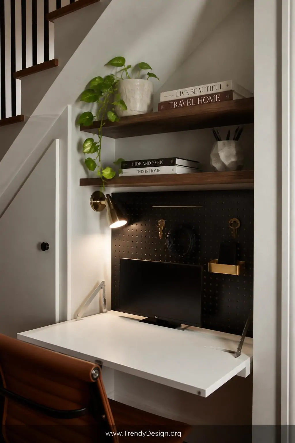 Close-up photorealistic interior shot of a compact under-stair home office nook featuring a sleek white floating fold-down wa