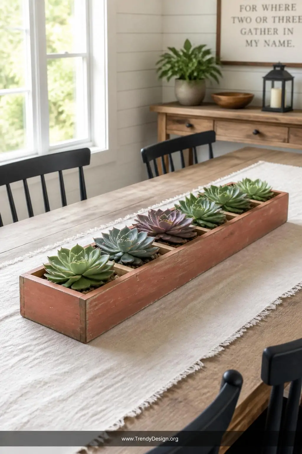 A wide-shot photorealistic interior of a sunlit dining table centerpiece featuring a terracotta-painted rectangular wooden pl