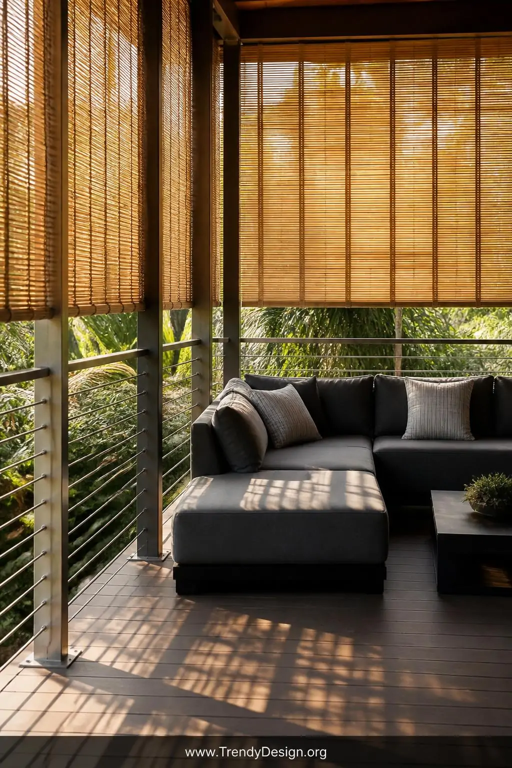 A wide elevated deck scene featuring taut stainless steel horizontal cable railings backed by natural bamboo roll screens in