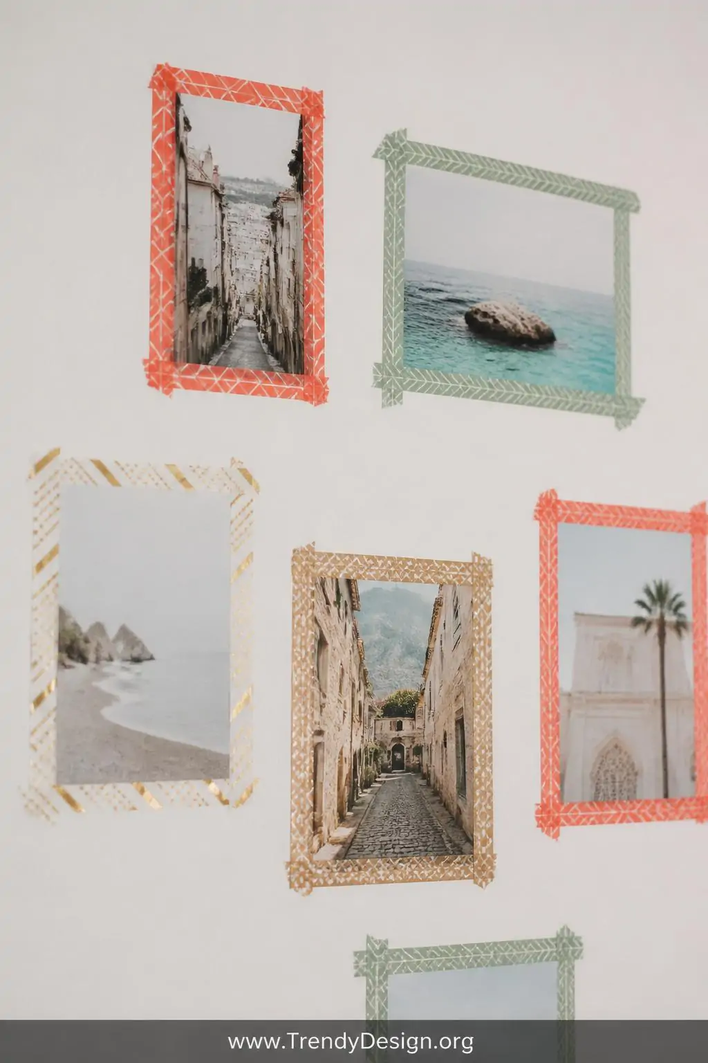 A closeup shot of a smooth matte white wall section where printed photo cards are framed with geometric washi tape borders in