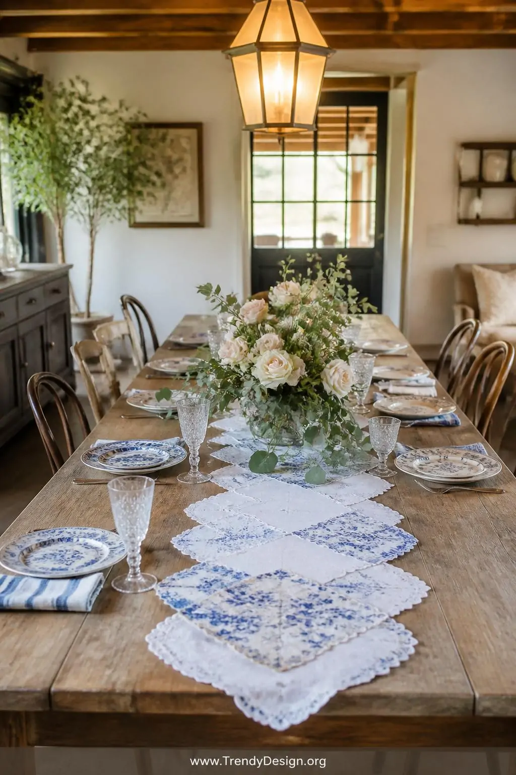 Wide shot of a rustic farmhouse dining table set for brunch, a flowing table runner of seven overlapping vintage handkerchief
