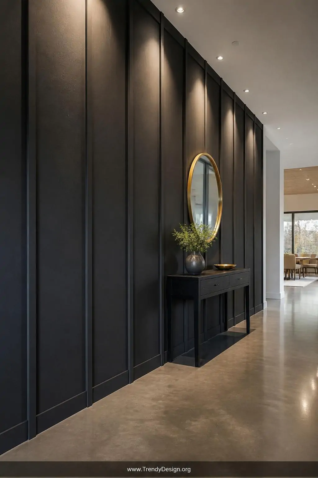 Wide shot of a dramatic hallway with full-ceiling-height board and batten wainscoting painted deep charcoal gray, battens spa