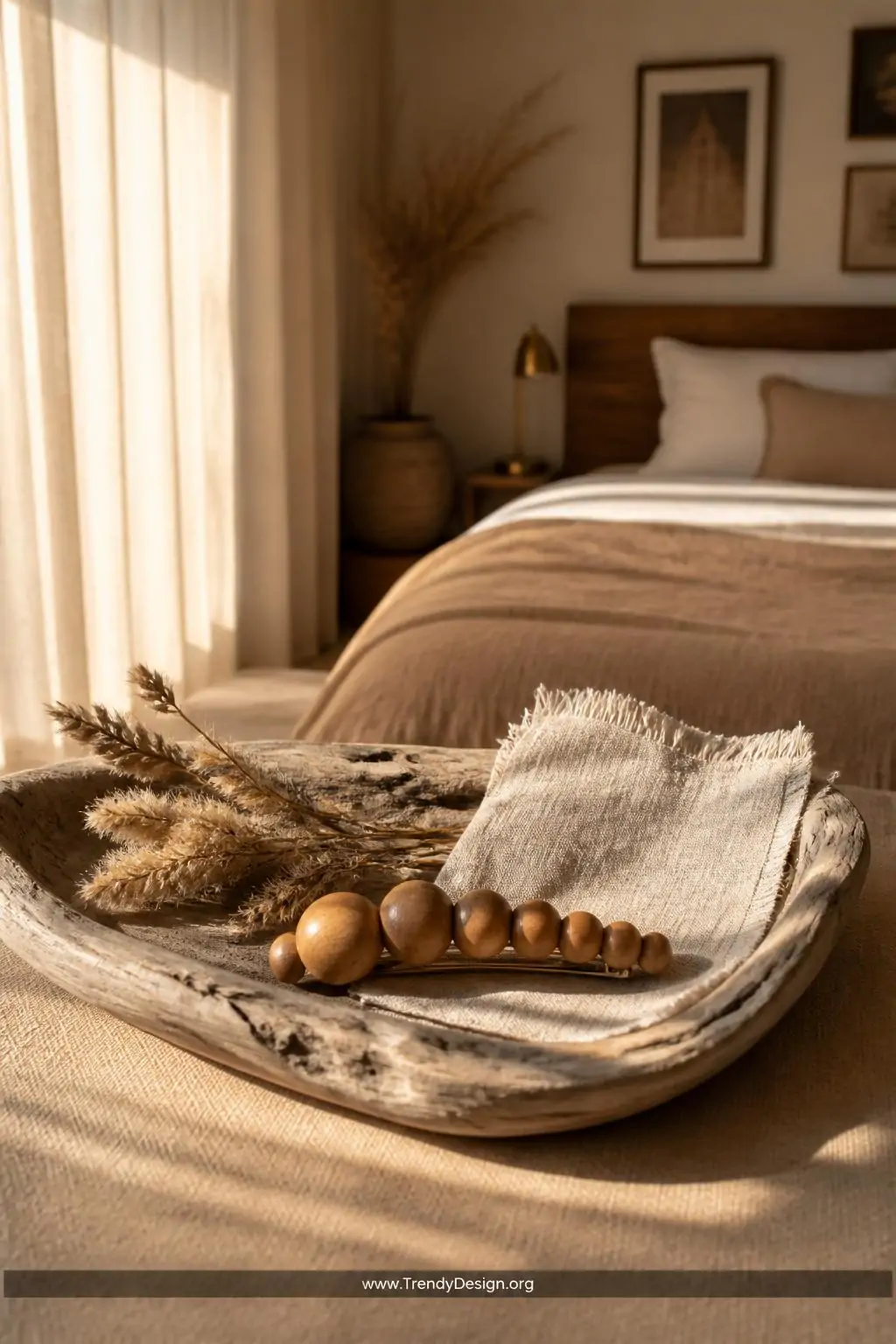 Smooth honey-stained wooden bead barrette resting on a weathered driftwood tray beside dried pampas grass and a linen fabric swatch, warm golden hour light streaming through sheer curtains, earthy boho bedroom, medium shot.