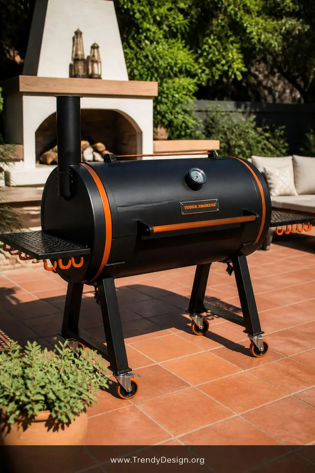 Powder-coated matte black steel drum smoker on a paved backyard patio, contemporary outdoor living space, bold glossy-to-matte black finish with deep burnt orange trim detail, bright midday sunlight casting a hard clean shadow across the smooth painted surface, heat-cured paint gleaming against terracotta tile flooring, medium shot.