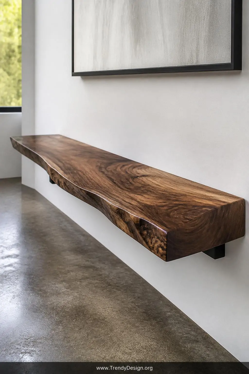 Closeup medium shot of a sleek live-edge walnut floating bench mounted flush against a matte white wall, thick natural oil fi