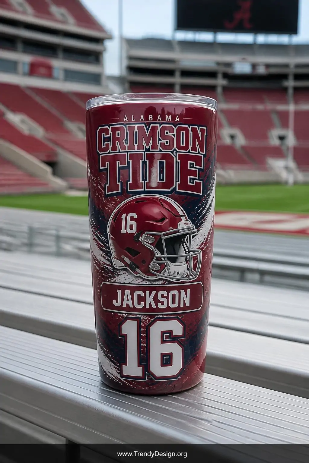A medium shot of a glossy sublimation tumbler placed on a bleacher seat plank surface, wrapped in a full bold sports design f