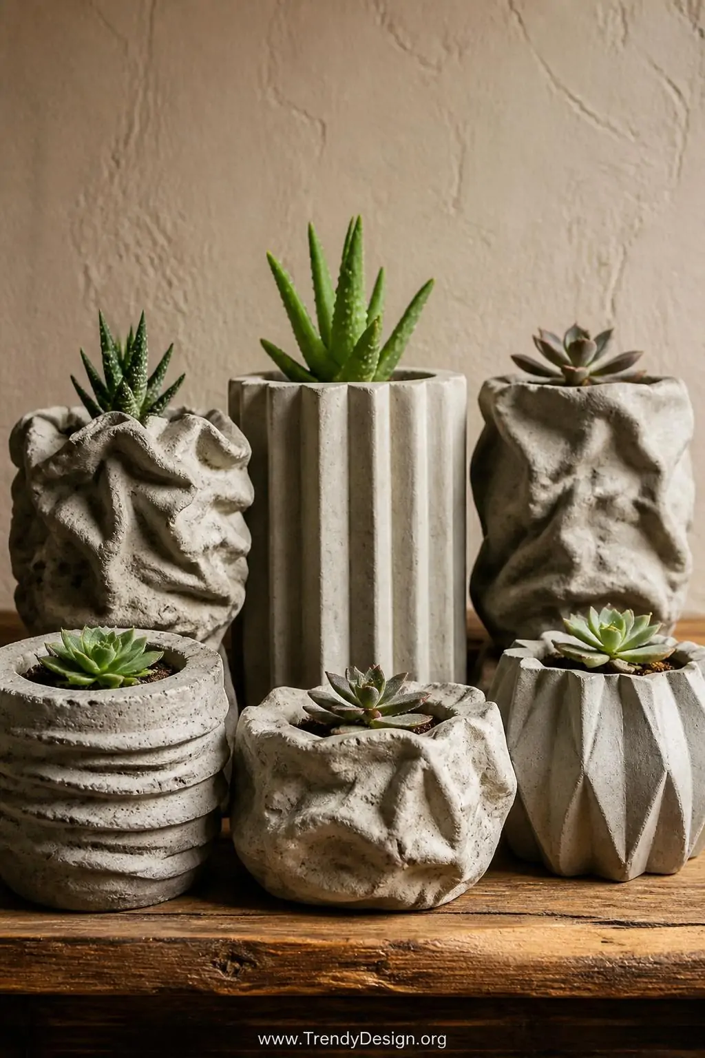 A medium closeup of an eclectic collection of upcycled mold concrete planters in various organic shapes arranged on a rustic 