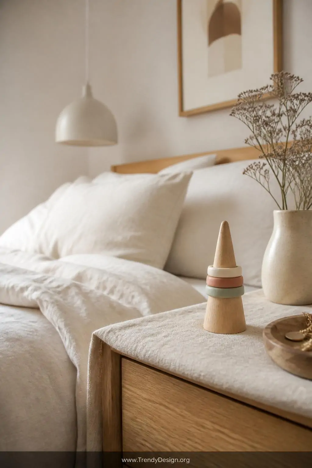 Set of minimalist thin band polymer clay rings in cream, dusty rose, and sage green stacked on a wooden ring cone atop a linen-draped nightstand, Scandinavian bedroom, soft neutral style, medium shot with warm diffused morning light