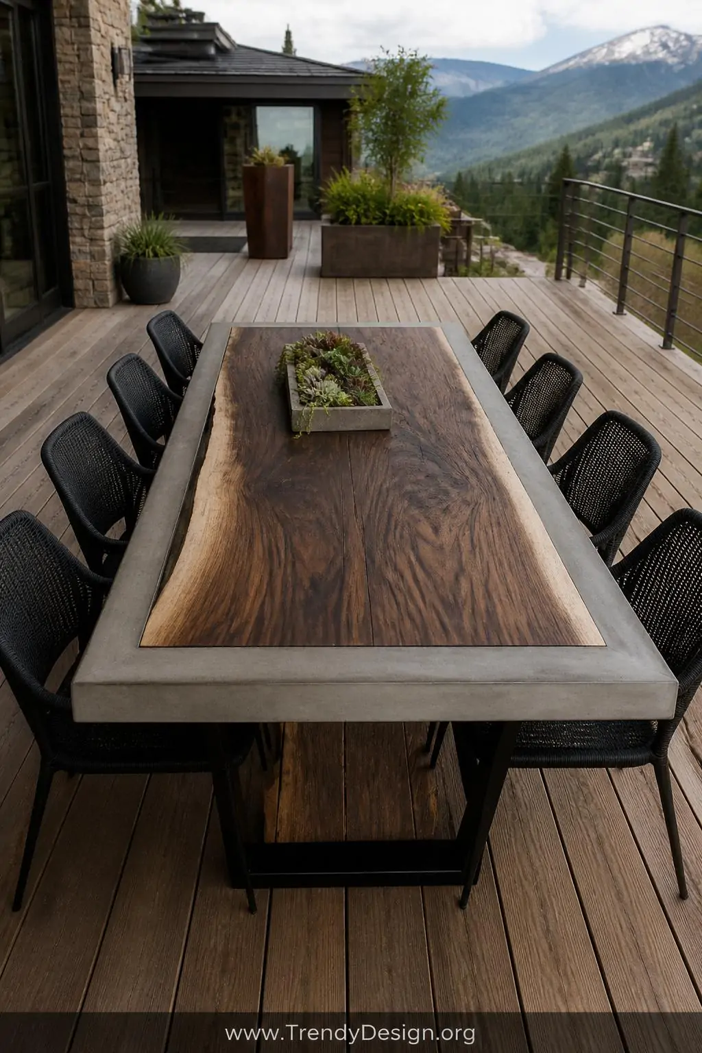 Concrete and live-edge walnut slab farmhouse outdoor dining table with rich dark wood grain set into a gray concrete border frame, flexible sealed seam visible, soft diffused natural daylight, wide shot on a sprawling wooden deck, photorealistic.