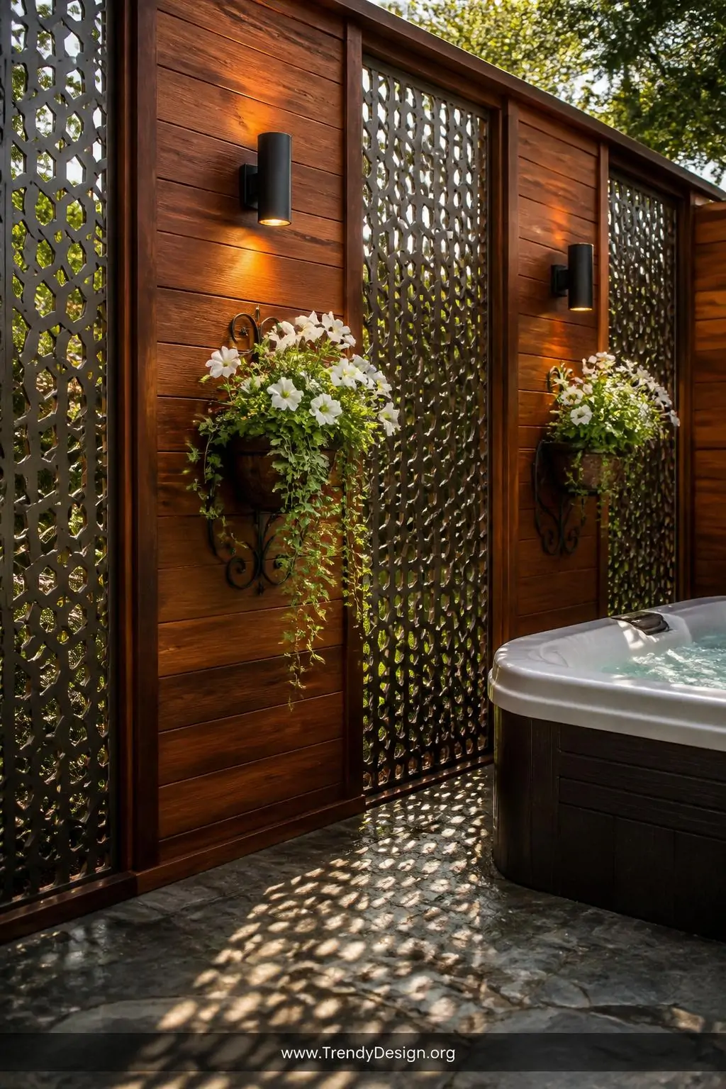 Medium photorealistic shot of a cedar privacy fence with decorative laser-cut metal screen panels flanking a hot tub, rich wa